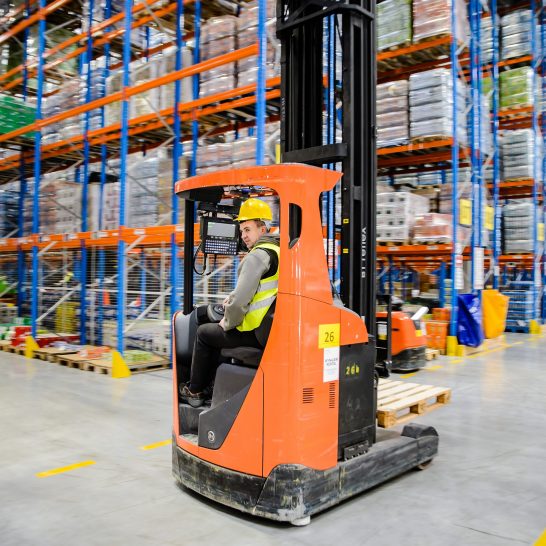 ID Logistics employee in a forklift in a warehouse.