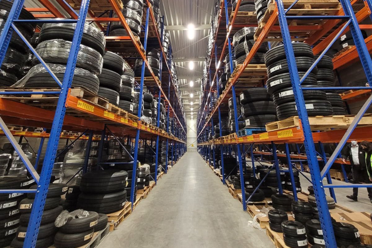 Tyres stored in racks in an ID Logistics warehouse.