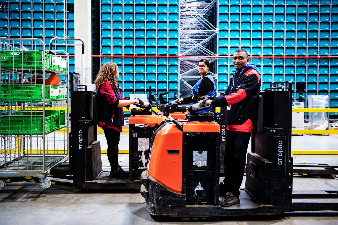 Forklift operators in a warehouse.
