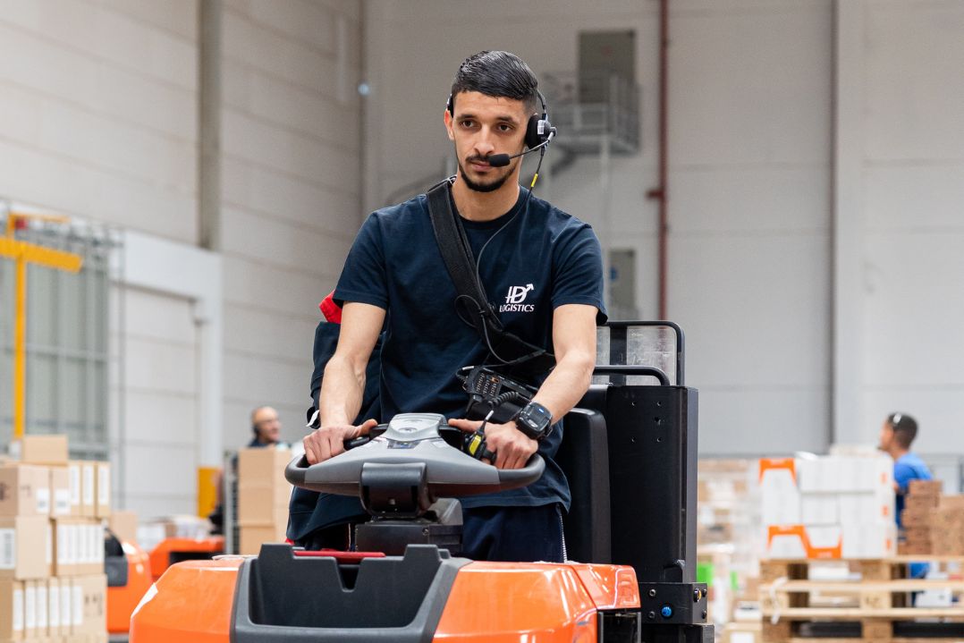 Forklift operator in a warehouse.