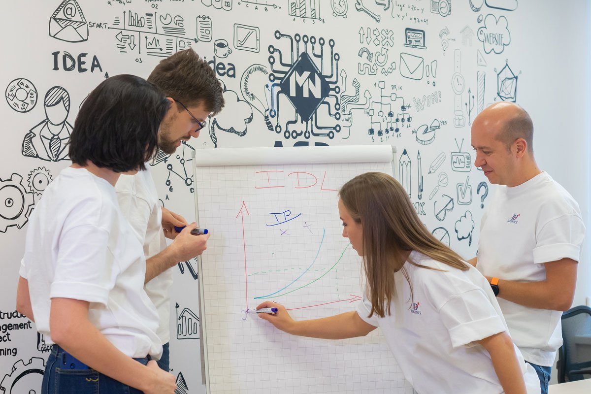 ID Logistics employees writing on a board.