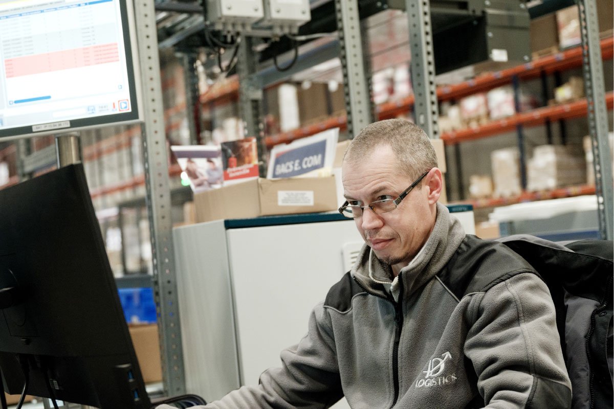ID Logistics employee working on a computer.