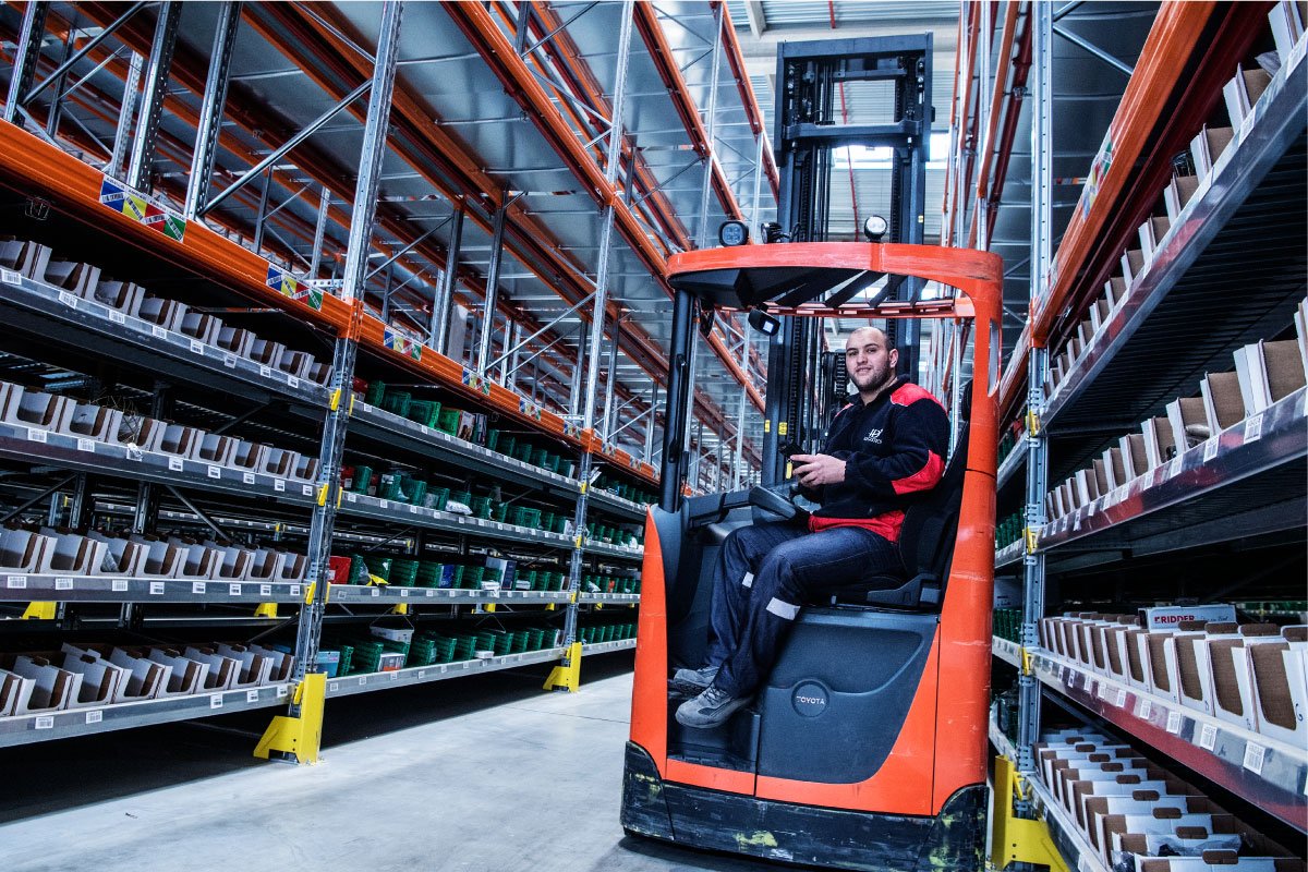 Forklift operator in an ID Logistics warehouse.